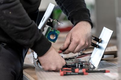 Männerhände schrauben Ersatzteil